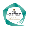 The green, circle-like logo features the words "TOP ARBEITGEBER Hospitality HR Award" in a circle. A crown is depicted above "Top."