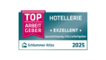 Siegel-Datei mit dunkelblauem Hintergrund. Auf einer roten Schärpe steht "TOP ARBEITGEBER" daneben in weißer Schrift "Hotellerie" und "Exzellent"