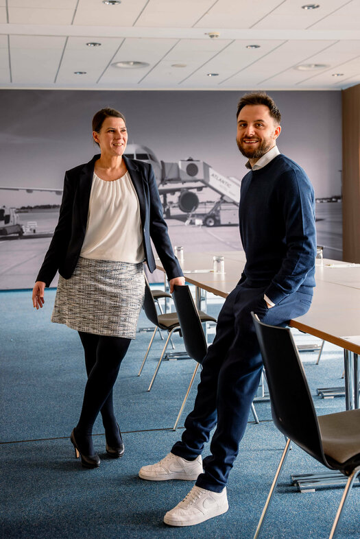 Hotel manager chatting with her assistant in an event room